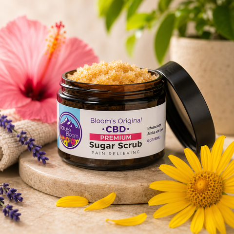 Jar of Bloom's Original CBD Premium Sugar Scrub with flowers and plants in the background