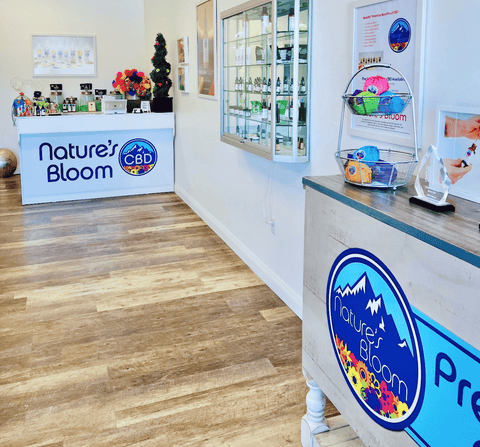 Interior of a store with 'Nature's Bloom' branding on product displays and signage.
